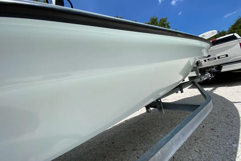 Slide: The Image of 2019 Cayo Boatworks 173 on trailer, parked beside a white truck under a clear blue sky. - 15