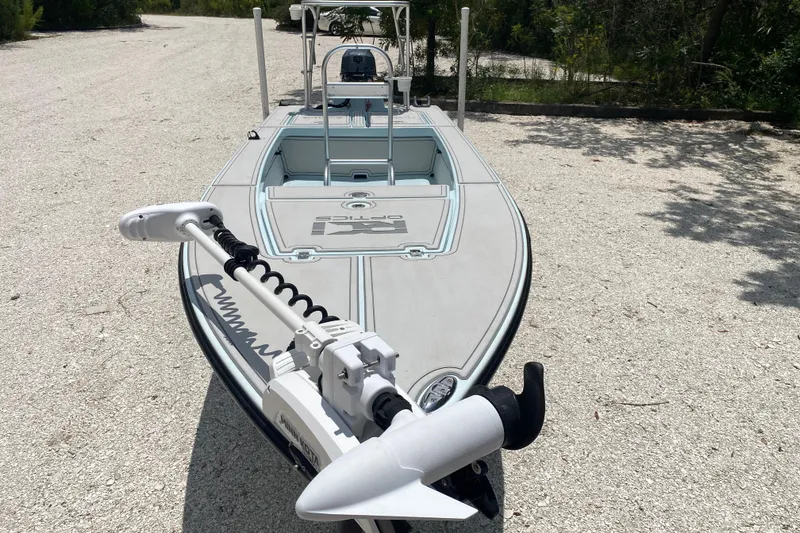 Slide: The Image of 2019 Cayo Boatworks 173 skiff with trolling motor on gravel path. - 18