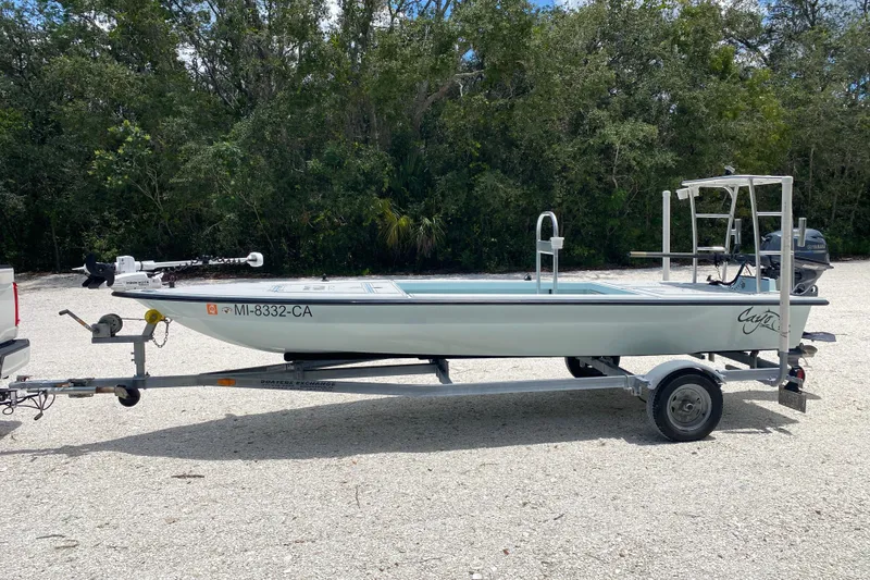 Slide: The Image of 2019 Cayo Boatworks 173 on trailer, parked outdoors with forest background. - 2