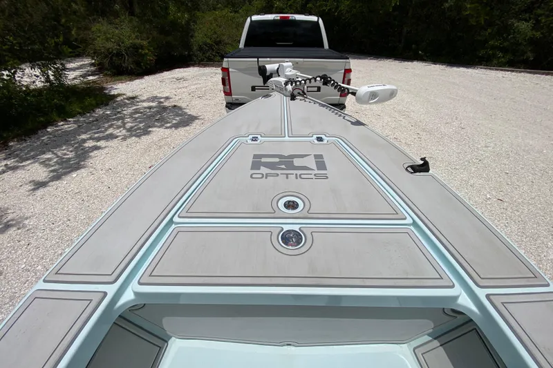 Slide: The Image of 2019 Cayo Boatworks 173 on trailer, parked behind a truck in a gravel area. - 20