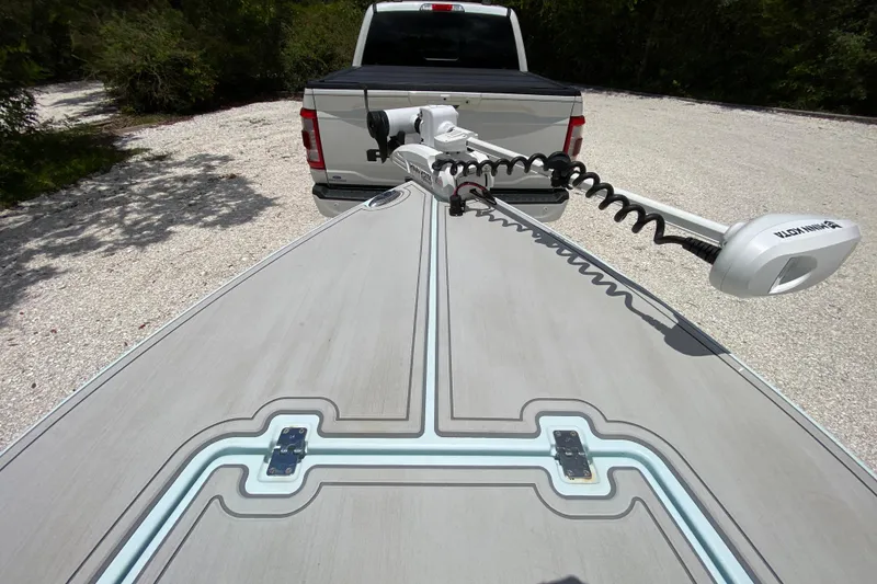 Slide: The Image of 2019 Cayo Boatworks 173 with trolling motor, parked behind a white truck. - 22