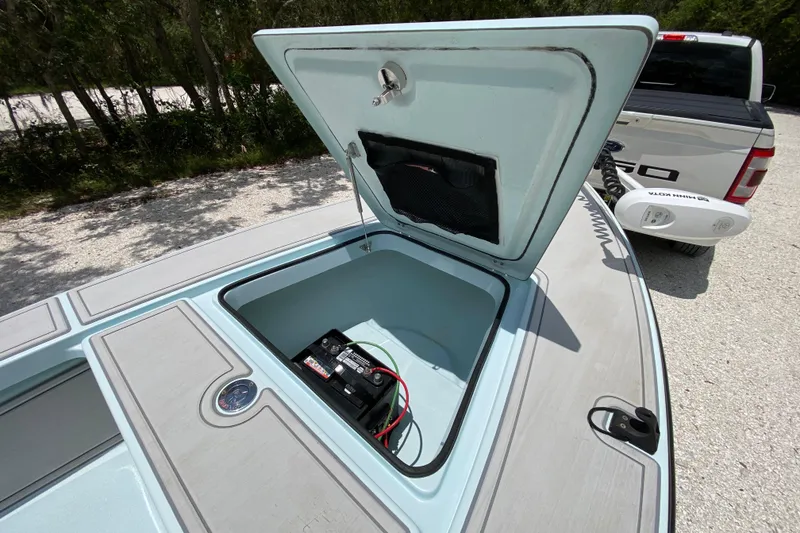 Slide: The Image of Open storage compartment on 2019 Cayo Boatworks 173, showing battery and wiring. - 25