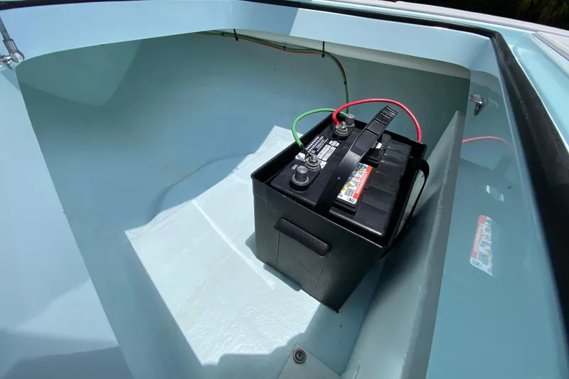 Slide: The Image of Battery compartment of 2019 Cayo Boatworks 173 with visible wiring connections. - 27