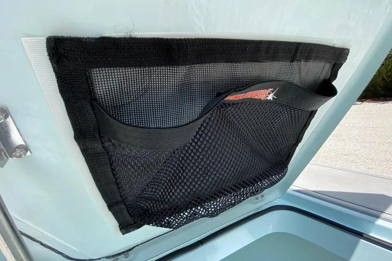 Slide: The Image of Mesh storage pocket inside 2019 Cayo Boatworks 173, featuring secure netting and Velcro closure. - 29