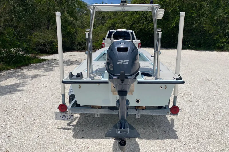 Slide: The Image of 2019 Cayo Boatworks 173 with 25HP outboard motor on trailer, parked outdoors. - 4