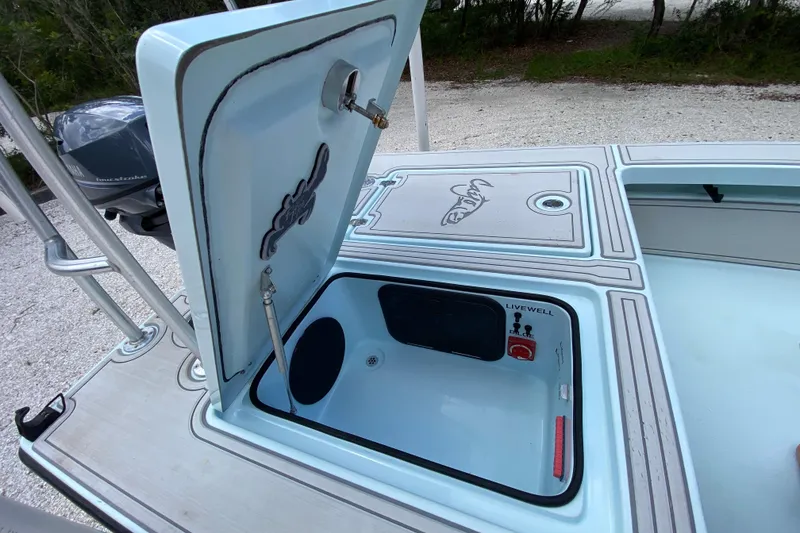 Slide: The Image of Open livewell compartment on 2019 Cayo Boatworks 173, showcasing interior features and design. - 48