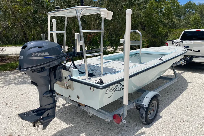 Slide: The Image of 2019 Cayo Boatworks 173 with Yamaha outboard motor on trailer, parked outdoors. - 5