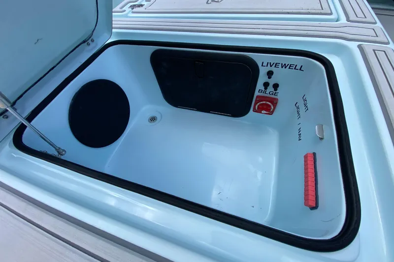 Slide: The Image of Livewell compartment in 2019 Cayo Boatworks 173 boat, featuring bilge and light controls. - 50