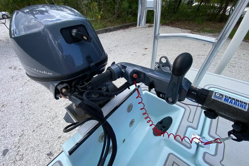Slide: The Image of 2019 Cayo Boatworks 173 outboard motor and steering controls on a boat deck. - 55