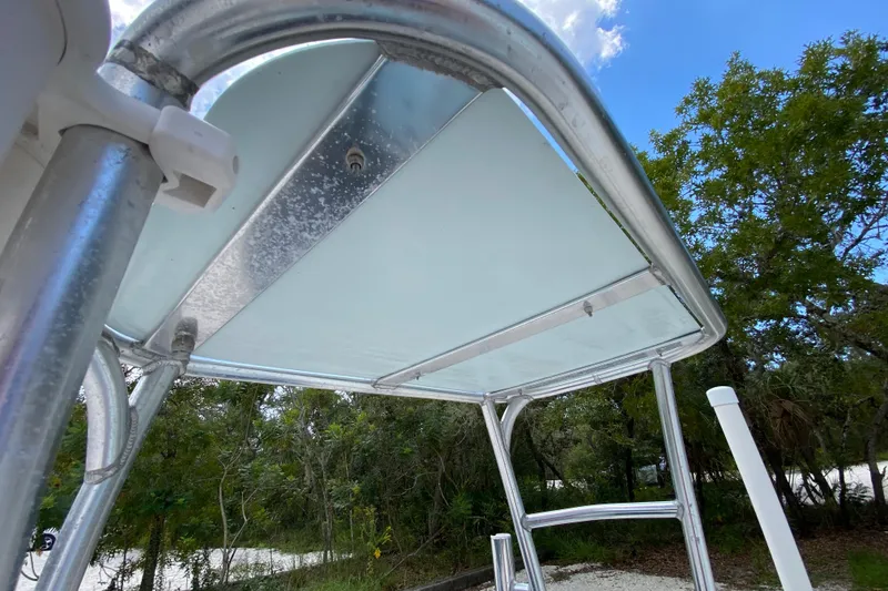 Slide: The Image of 2019 Cayo Boatworks 173 T-top structure with clear sky and trees in background. - 56