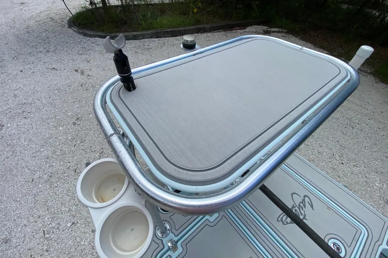 Slide: The Image of 2019 Cayo Boatworks 173, featuring a sleek deck with cup holders and rod holder. - 57