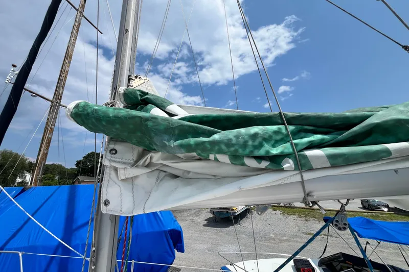 Slide: The Image of Sailboat mast and sails of a 1995 Hunter 29.5 under a clear sky. - 14