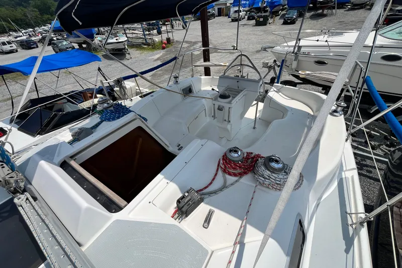 Slide: The Image of 1995 Hunter 29.5 sailboat cockpit with ropes and winches, docked in a marina. - 17