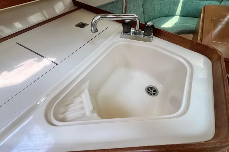 Slide: The Image of Compact kitchen sink in a 1995 Hunter 29.5 sailboat interior. - 28