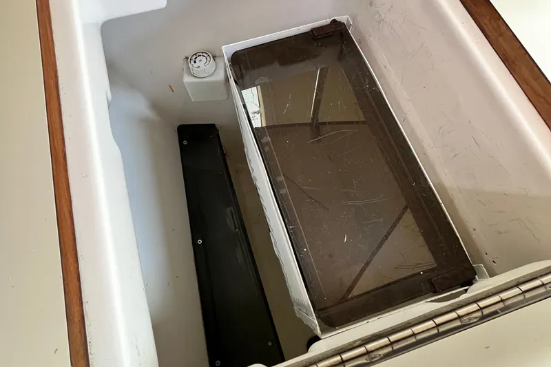 Slide: The Image of Interior of a 1995 Hunter 29.5 sailboat compartment with storage and gauge. - 29