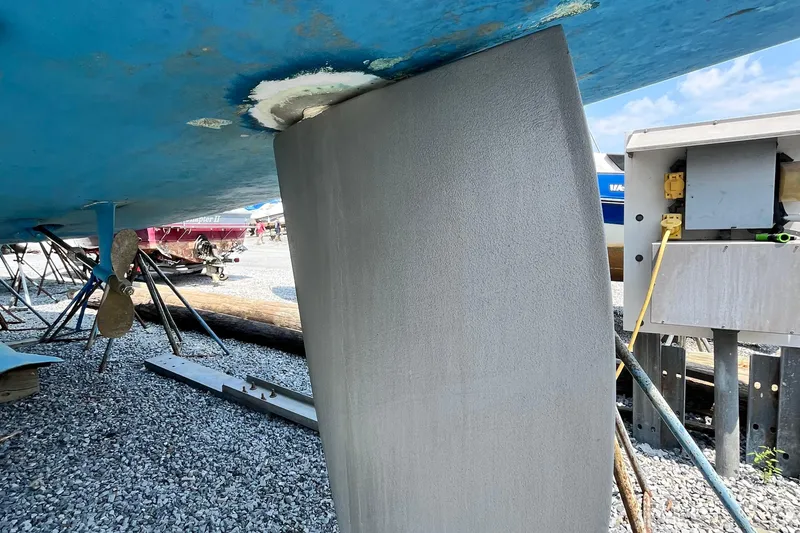Slide: The Image of 1995 Hunter 29.5 sailboat keel and propeller in a boatyard setting. - 3