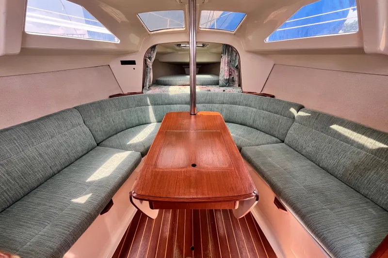 Slide: The Image of Interior of 1995 Hunter 29.5 sailboat with cozy seating and wooden table. - 33