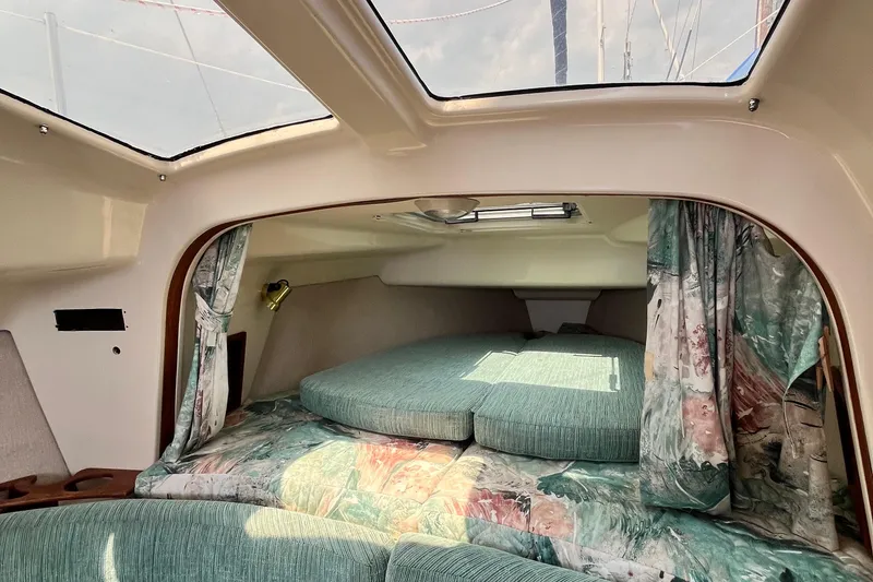 Slide: The Image of Cozy cabin interior of a 1995 Hunter 29.5 sailboat with floral decor. - 35