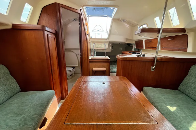 Slide: The Image of Interior of 1995 Hunter 29.5 sailboat with wood finish and seating area. - 36