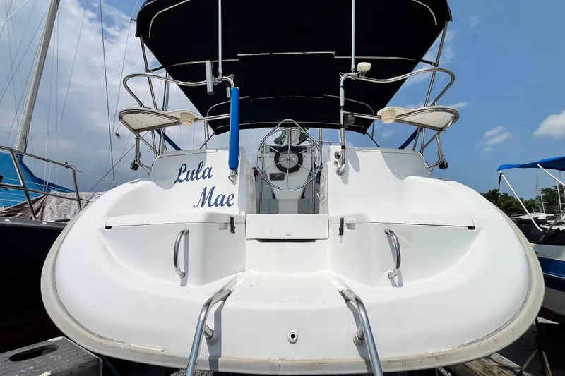 Slide: The Image of Hunter 29.5 sailboat, 1995 model, named "Lula Mae," docked under a clear sky. - 5
