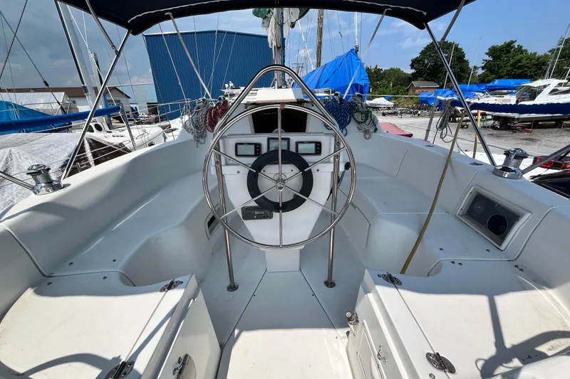 Slide: The Image of Cockpit of 1995 Hunter 29.5 sailboat with steering wheel and navigation instruments. - 6