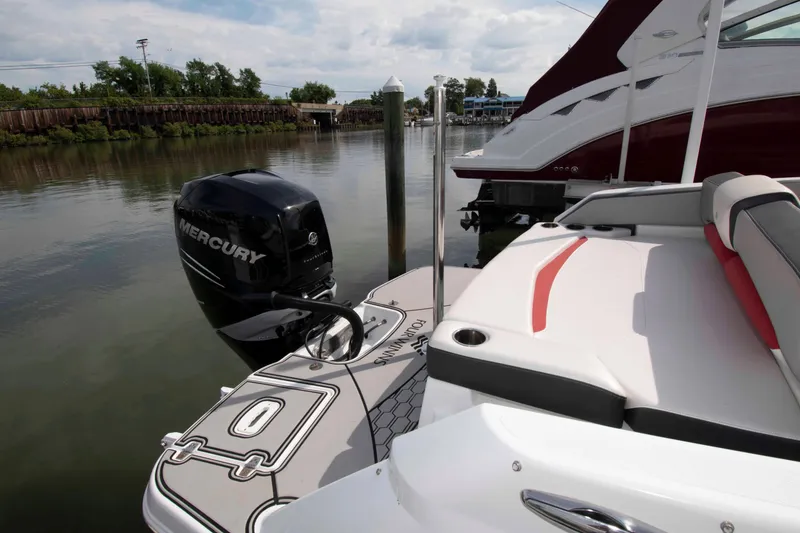 Slide: The Image of 2022 Four Winns HD8 boat with Mercury engine docked on calm water. - 11