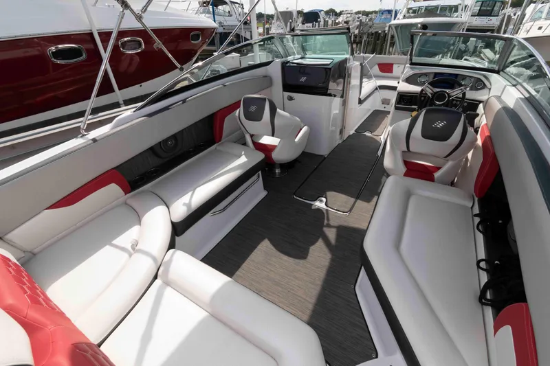 Slide: The Image of 2022 Four Winns HD8 boat interior with luxurious seating and modern dashboard. - 2