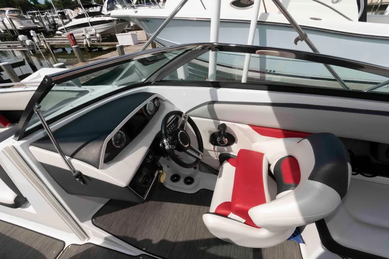 Slide: The Image of 2022 Four Winns HD8 boat cockpit with modern steering and red-white seating. - 4