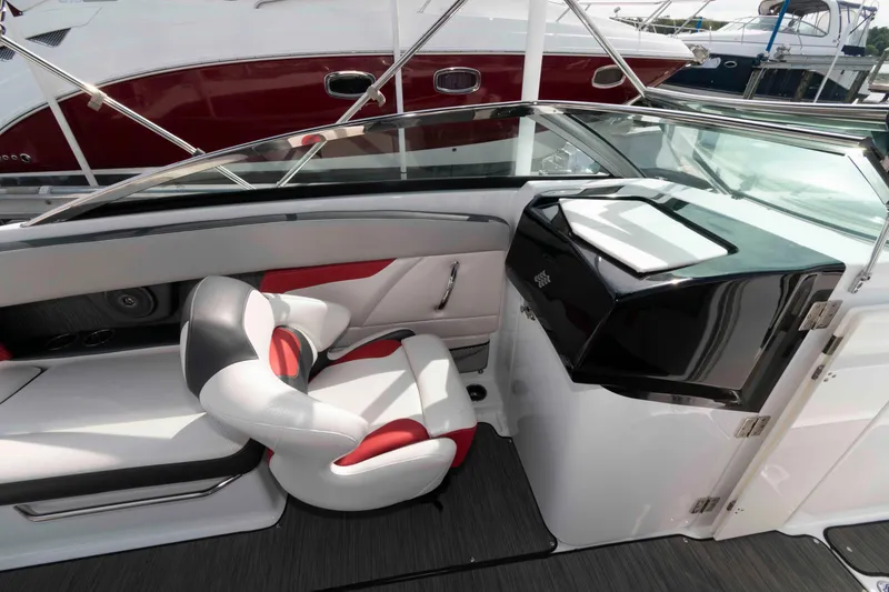 Slide: The Image of 2022 Four Winns HD8 boat interior with modern seating and sleek dashboard design. - 6