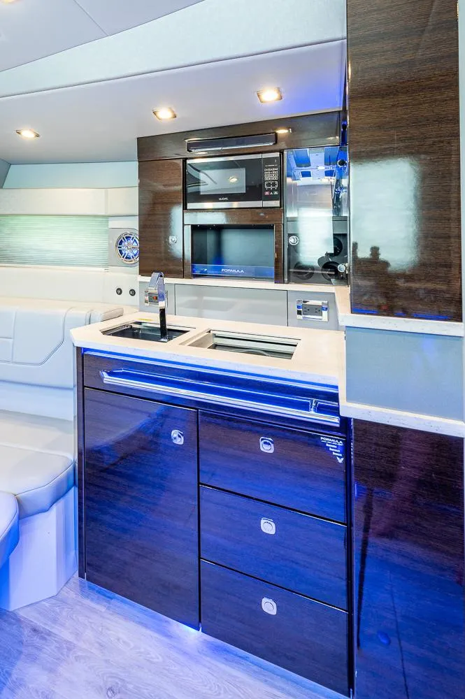 Slide: The Image of 2019 Formula 430 Super Sport Crossover yacht interior with modern kitchen amenities. - 12