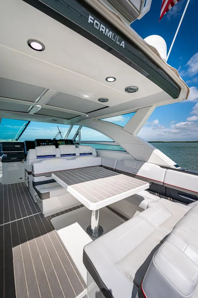 Slide: The Image of 2019 Formula 430 Super Sport Crossover yacht interior with seating and table, ocean view. - 21