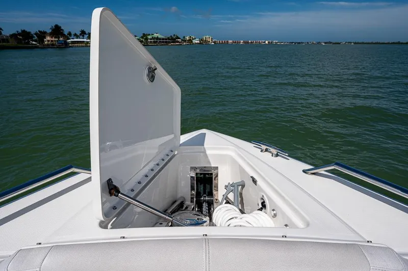 Slide: The Image of 2019 Formula 430 Super Sport Crossover boat anchor compartment open on calm water. - 4