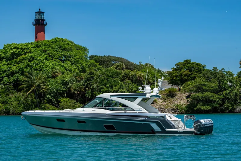 Slide: The Image of 2019 Formula 430 Super Sport Crossover yacht near lush island and lighthouse. - 69