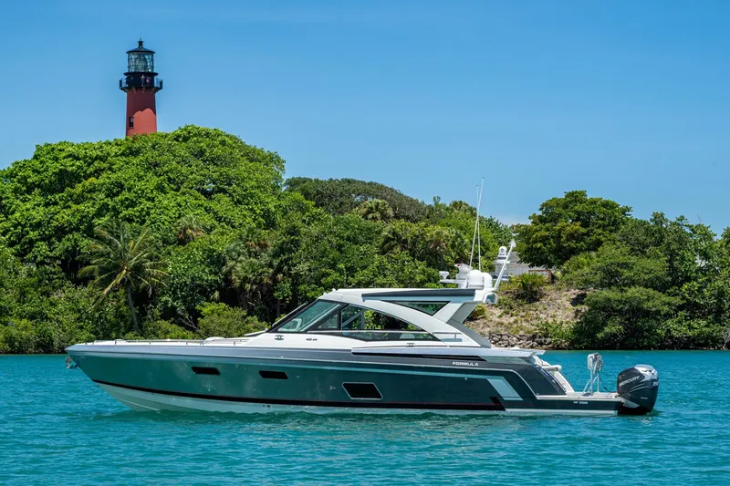 Slide: The Image of 2019 Formula 430 Super Sport Crossover yacht near lush island with lighthouse. - 70