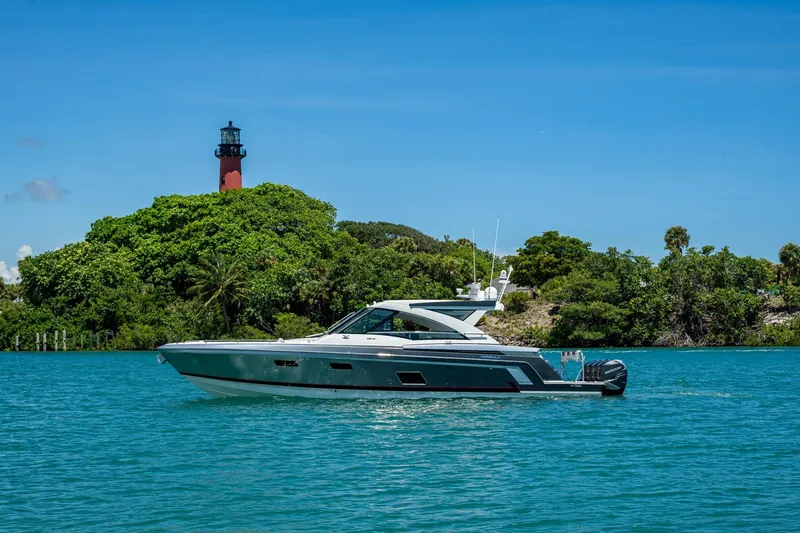Slide: The Image of 2019 Formula 430 Super Sport Crossover yacht near lush island and lighthouse. - 71