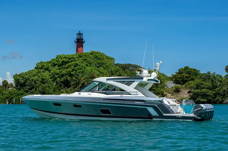 Slide: The Image of 2019 Formula 430 Super Sport Crossover yacht near lush island and lighthouse. - 73