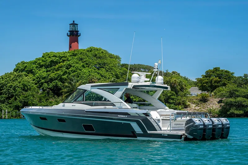 Slide: The Image of 2019 Formula 430 Super Sport Crossover yacht near a lighthouse, surrounded by lush greenery. - 75