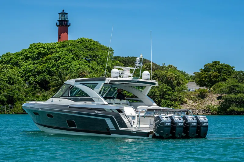 Slide: The Image of 2019 Formula 430 Super Sport Crossover yacht cruising near a lighthouse and lush greenery. - 76