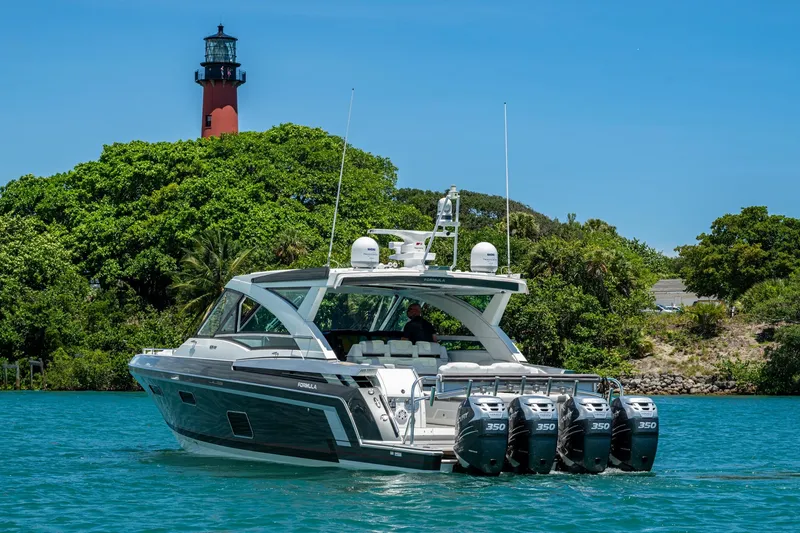 Slide: The Image of 2019 Formula 430 Super Sport Crossover yacht cruising near a lighthouse and lush greenery. - 77