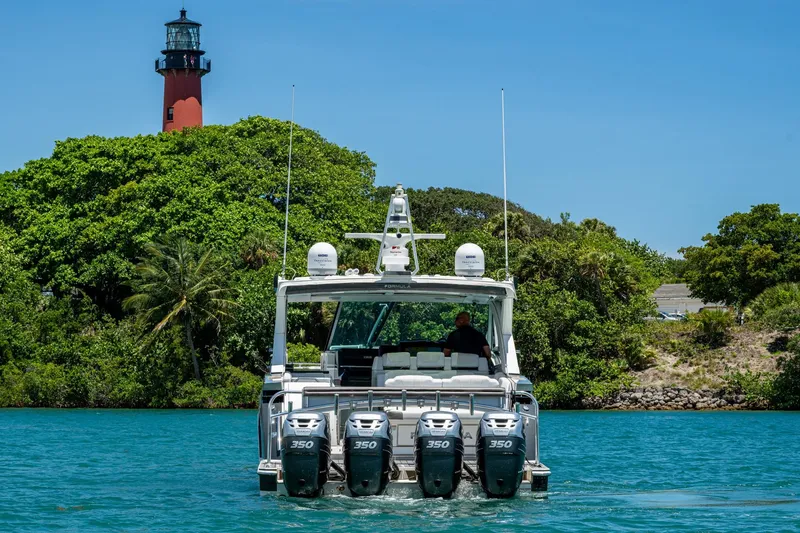 Slide: The Image of 2019 Formula 430 Super Sport Crossover boat cruising near a lighthouse and lush greenery. - 78