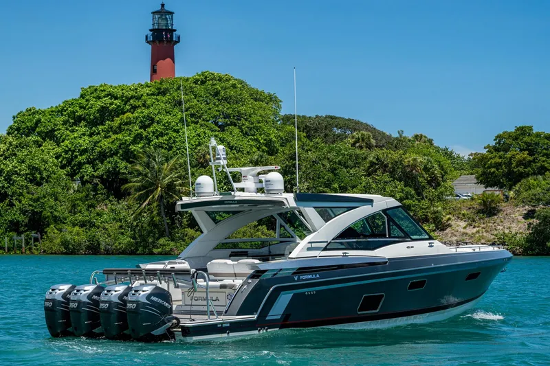 Slide: The Image of 2019 Formula 430 Super Sport Crossover yacht cruising near a lighthouse and lush greenery. - 79