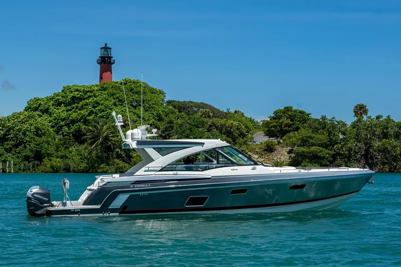 Slide: The Image of 2019 Formula 430 Super Sport Crossover yacht near lush island and lighthouse. - 82