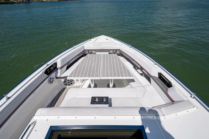Slide: The Image of 2019 Formula 430 Super Sport Crossover boat deck with seating and table on water. - 9