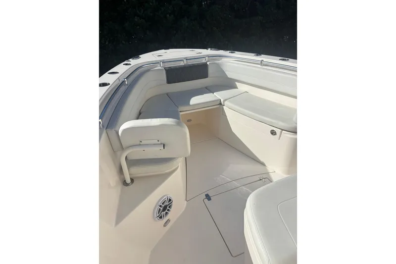 Slide: The Image of 2022 Cobia 280 Center Console boat interior with cushioned seating and speaker. - 11