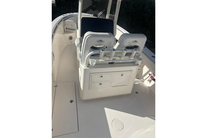Slide: The Image of 2022 Cobia 280 Center Console boat interior with seating and storage compartments. - 12