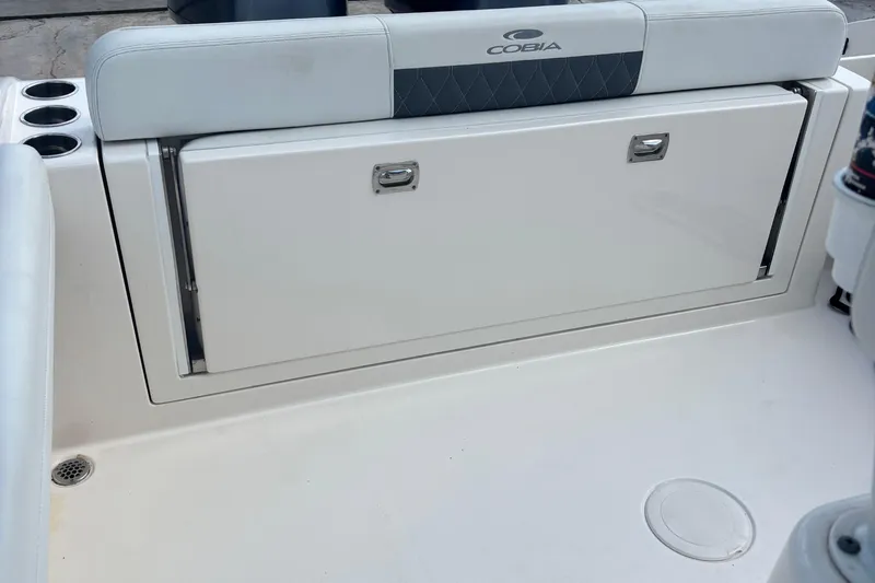 Slide: The Image of 2022 Cobia 280 Center Console boat seating and storage compartment. - 3
