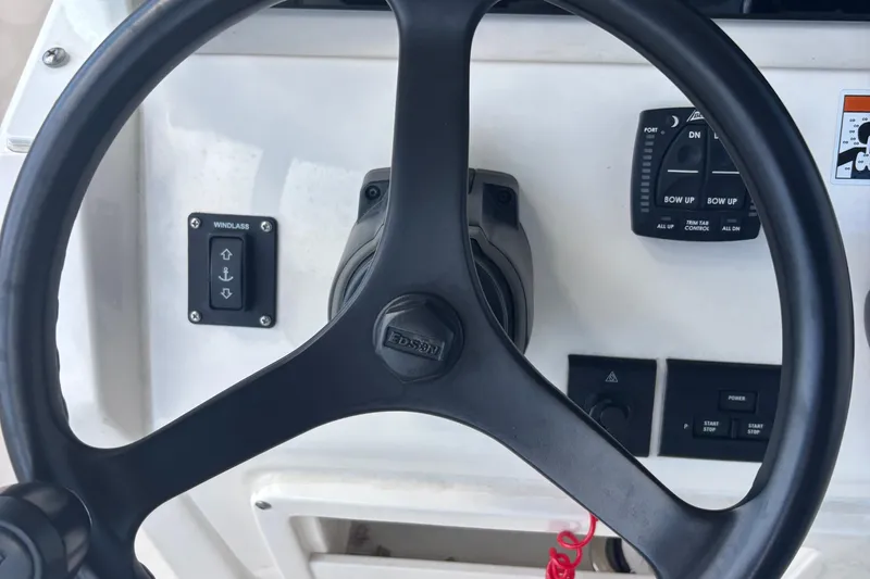 Slide: The Image of Steering wheel and controls of 2022 Cobia 280 Center Console boat. - 4