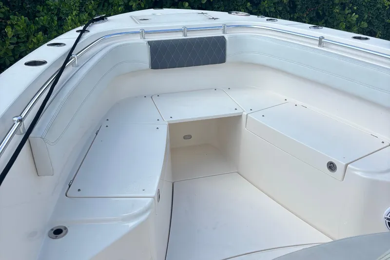 Slide: The Image of 2022 Cobia 280 Center Console boat interior with seating and storage compartments. - 7