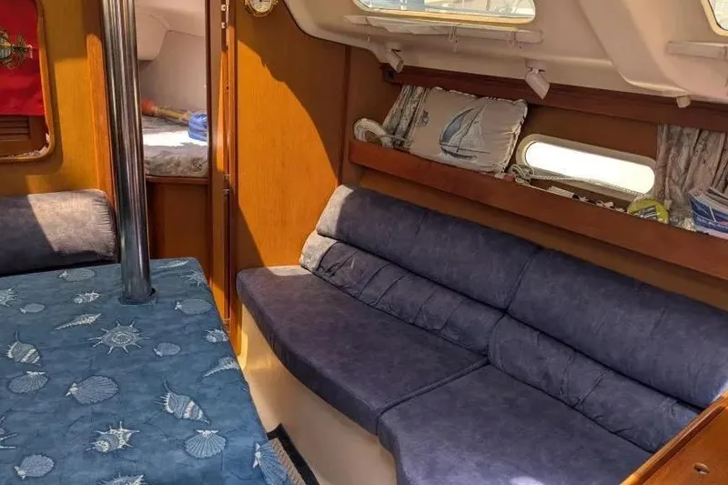 Slide: The Image of Interior of 1998 Hunter 34 sailboat with blue seating and nautical decor. - 10