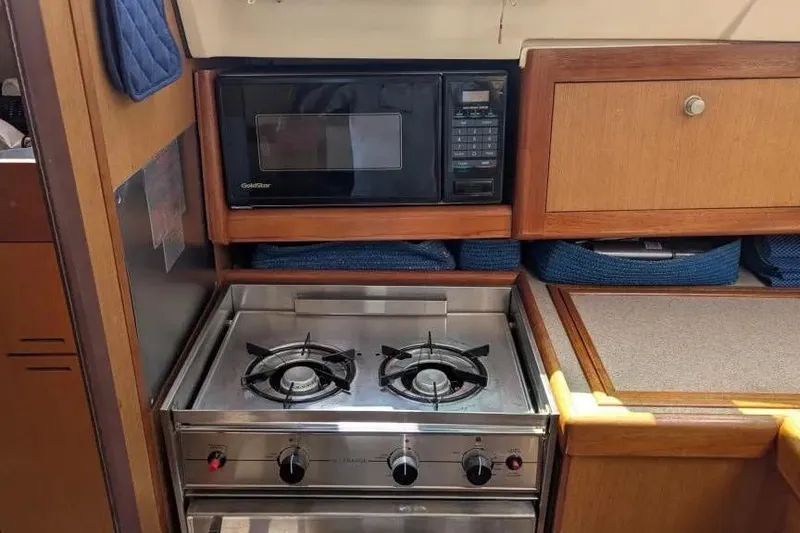 Slide: The Image of Compact kitchen in 1998 Hunter 34 sailboat with stove and microwave. - 11